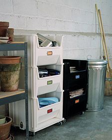 the shelves are full of pots and other things in their bins, including plants