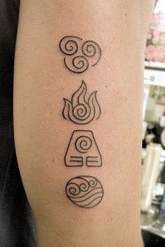 a tattoo with four symbols on it