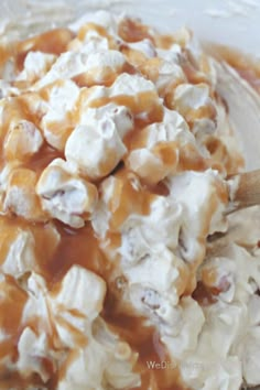 a bowl filled with marshmallows and caramel sauce