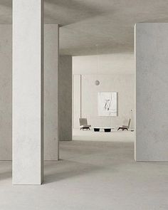 an empty room with white walls and chairs