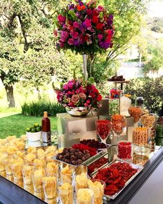 a buffet table filled with lots of food and wine glasses on top of the table