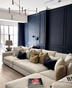 a living room filled with furniture and blue walls