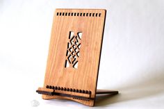 a wooden notebook holder with an intricate design