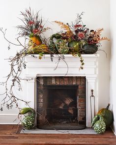 the fireplace is decorated with flowers and plants