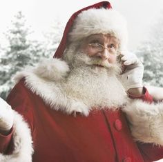 a man dressed as santa claus talking on the phone