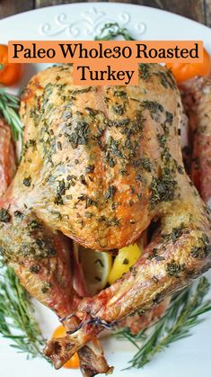 a roasted turkey on a platter with tomatoes and herbs