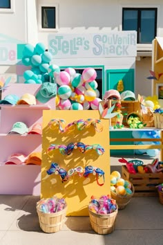 an assortment of colorful items on display in front of a storefront with shelves and baskets