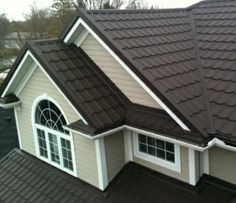 a house with a brown roof and white trim