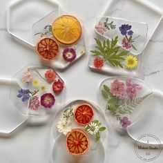 four plates with flowers and fruit on them