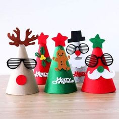 paper christmas trees with santa hats and glasses on them, all decorated in different colors