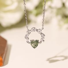 Cue the romance with our stunning Heart’s Desire Moss Agate Necklace. This perfect expression of true love features a natural charm of a wreath-like pendant with a heart-shaped moss agate gem at the center. A cherished keepsake that radiates love from every angle. ✦ 14K White Gold Vermeil (14K white gold plated over a sterling silver base) Nature-inspired Necklace With Round Pendant For Anniversary, Nature-inspired Round Pendant Necklace For Anniversary, Nature-inspired Silver Heart Necklace, Nature-inspired Round Necklace For Anniversary, Nature-inspired Round Anniversary Necklaces, Nature-inspired Round Anniversary Necklace, Nature-inspired Round Pendant Necklace For Wedding, Nature-inspired Moss Agate Jewelry For Anniversary, Elegant Moss Agate Pendant Necklace