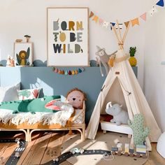 a child's bedroom with a teepee tent and toys