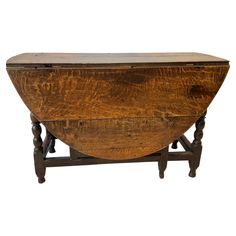 an old wooden table with two legs and a large bowl on it's top