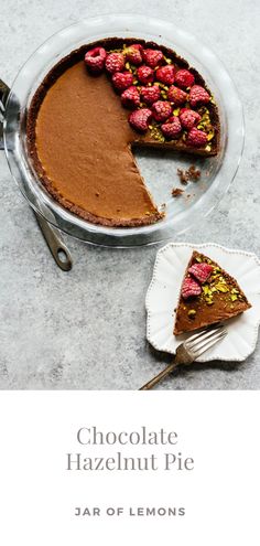 chocolate hazelnut pie with raspberries and pistachios on the top