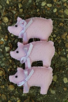 two stuffed pigs are laying on the ground