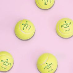 four yellow tennis balls sitting on top of a pink surface with the words perfect match written on them