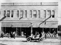 an old black and white photo of people standing in front of a building