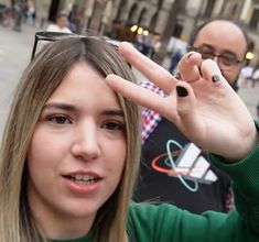 a woman making the v sign with her fingers