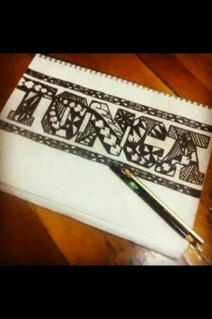 a pen sitting on top of a notebook with the word art written in black ink