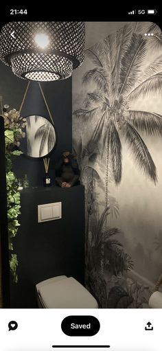 a bathroom with palm trees on the wall and a toilet in the corner next to it