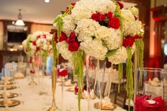 the centerpieces are filled with white and red flowers