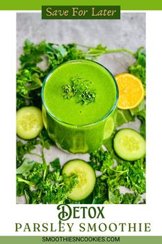 a green smoothie with cucumbers, oranges and parsley on the side