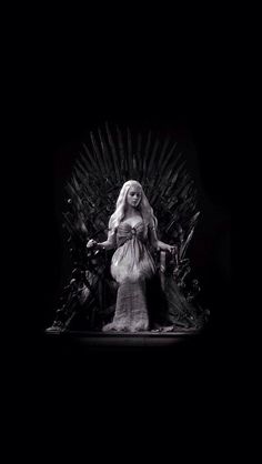 a woman sitting on top of a iron throne