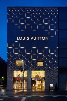 the louis vuitton store in paris is lit up at night with its lights on