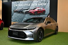 two cars parked next to each other in front of a large sign that says crown style talk show