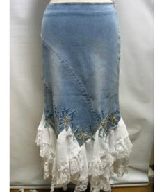 a woman's skirt with white lace on the bottom and blue denim below it