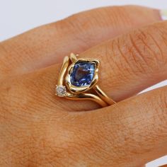 Modern yet forever timeless, this one-of-a-kind ring features a 1.18ct no heat sapphire with saturated blue hues. Wear this ring as an alternative engagement ring or statement cocktail ring. We love this design paired with white diamond bands... or let her beauty shine solo. Please note resizing this ring adds an extra 7-10 days for delivery. Asymmetrical Marquise Ring, Non Conventional Wedding Rings, Abstract Bezel Ring, Wedding Rings With Sapphires, Blue Sapphire Engagement Ring Vintage, Gold And Sapphire Ring, Pearl And Sapphire Ring, Bezel Sapphire Engagement Ring, Non Traditional Wedding Rings Engagement