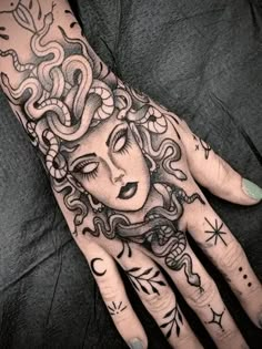 a woman's hand with tattoos on it