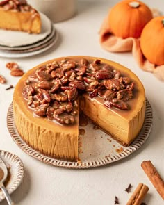 a pumpkin cheesecake with pecans on top