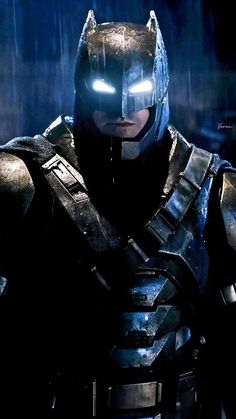 batman in the dark knight costume standing in the rain with his eyes open and glowing