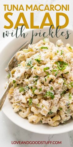 tuna macaroni salad with pickles in a white bowl on a marble table