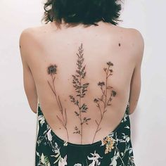 the back of a woman's body with flowers on it