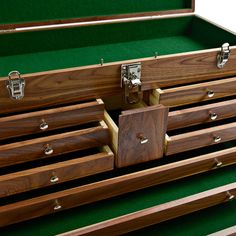 a large wooden chest with many drawers on it's sides and one drawer open