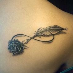 a tattoo with a rose and a feather on it