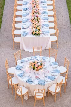 an overhead view of a long table set up with blue and pink flowers on it