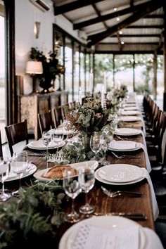 a long table set with plates and glasses