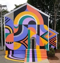 an artisticly painted building with steps leading up to it