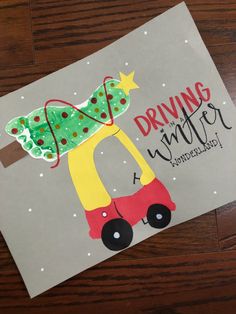 a christmas card with the words driving under a christmas tree on it and a handmade truck