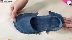 someone is removing the fabric from an old pair of jeans