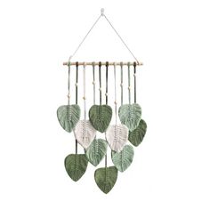 a green and white leaf mobile hanging on a wall