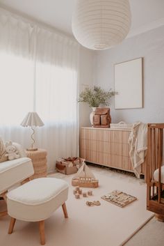 a baby's room with white walls and furniture