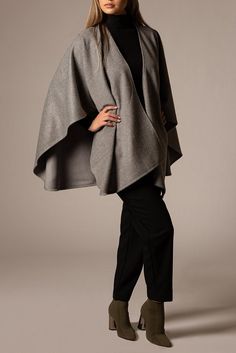 Design: Glamorous and very chic cape.     Material Composition: 70% Royal Suri Alpaca, 30% Wool.     Origin: Made in Peru.     Ethical Credentials: Fairtrade certified.     Additional Feature: Naturally dyed.     Quality: Made from high-quality alpaca wool, known for its softness, warmth, and sustainable properties.     Ideal for: Fashion-conscious individuals looking for eco-friendly alternatives. Oversized Chic Cape, Chic Shawl Cape For Fall, Oversized Cape Wraps For Fall, Chic One-size Cape For Layering, Chic One Size Cape For Layering, Oversized Fall Cape Wrap, Chic One-size Fall Cape, Elegant Winter Cape For Layering, Elegant Cape Poncho For Work