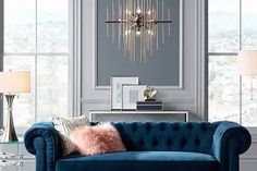 a living room with blue couches and chandelier