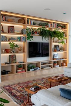 a living room filled with furniture and a flat screen tv on top of a wooden shelf