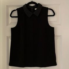 Black Sleeveless Top With Thick Satin Collar. Nice Weight To Fabric Adds Shape. Hidden Back Zip. Never Worn Perfect Condition Black Tank Top Vest For Workwear, Casual Black Blouse With Vest Detail, Casual Black Blouse With Vest, Casual Black Vest-style Blouse, Black Sleeveless Vest Blouse, Black Sleeveless Blouse Vest, Black Tank Blouse With Vest Detail, Black Vest Tank Blouse, Black Tank Vest Blouse