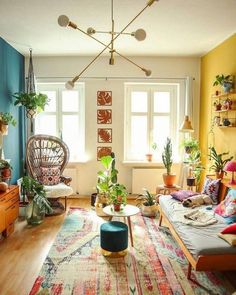 a living room filled with furniture and lots of plants